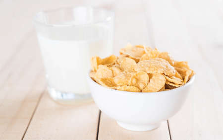 milk and cereal on wood tableの写真素材