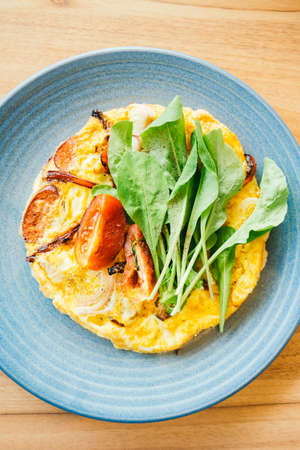 Fried eggs omelette in white plateの写真素材