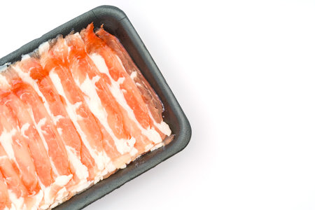 Slide of raw pork on white background .の写真素材