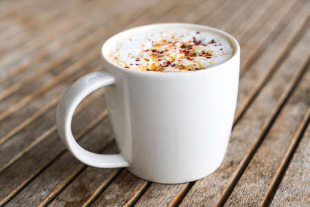 Latte Coffee art on the wooden tableの写真素材
