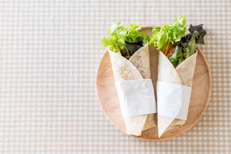 wrap salad roll on the tableの写真素材