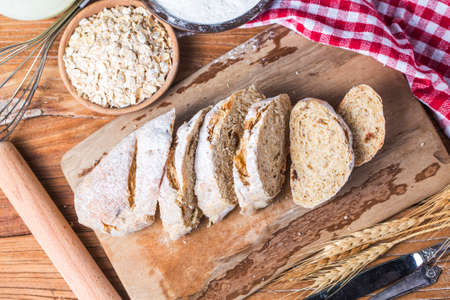 Freshly baked traditional bread on wooden table Oatmeal Bread