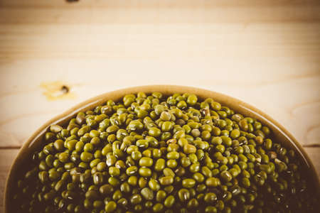 red beans on wood background - soft focus with vintage film filterの写真素材
