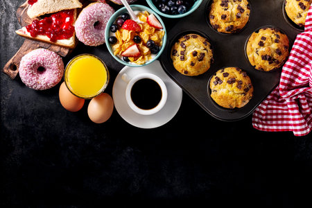 Tasty fresh breakfast food ingredients on black dark background. Ready to cook. Home Healthy Food Cooking Concept.の写真素材