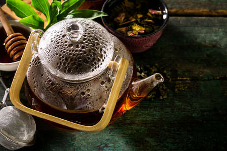Tasty Fresh Green Tea in Glass Teapot Ceremony on Old Rustic Tableの写真素材