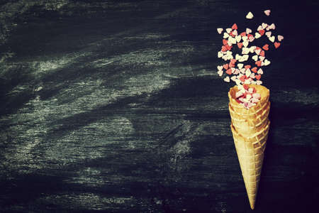 Ice Cream Horn with Sweethearts on a Chalkboard. Love, Valentines Day or Creative Concept. Top view