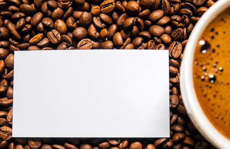 Coffee cup and coffee beans on table, top view, love coffee, Brown coffee beans isolated on white background, Hot Coffee cup with Coffee beansの写真素材
