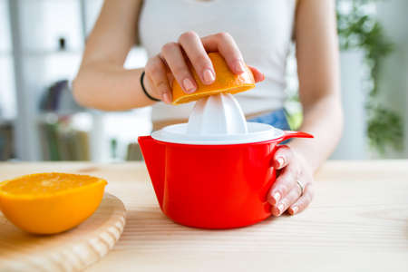Beautiful young woman preparing breakfast at home.の写真素材