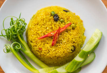 curry fried rice on wood backgroundの写真素材