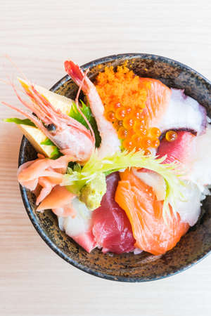 Japanese rice bowl with sashimi seafood on topの写真素材