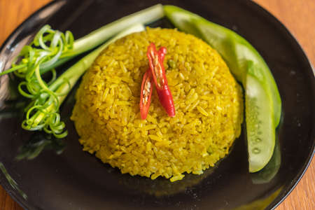 curry fried rice on wood background