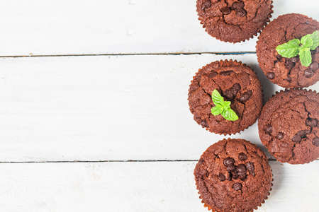 chocolate muffin with mint on a wooden tableの写真素材