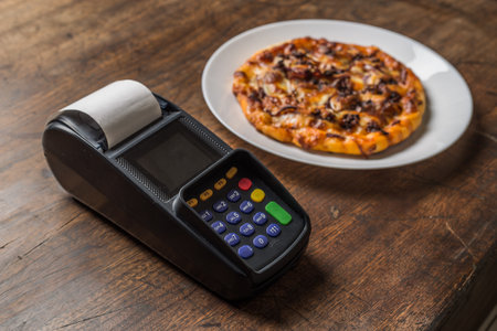 Delicious italian pizzas served on wooden tableの写真素材