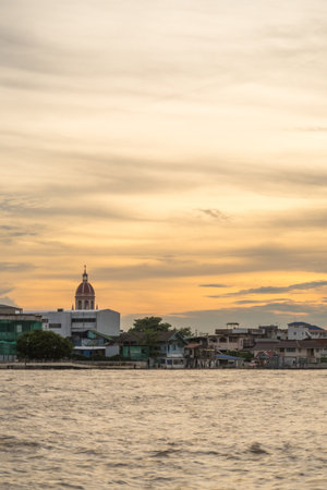 church is next to the river in Bangkok. And the belly covered the sky in the evening.の写真素材