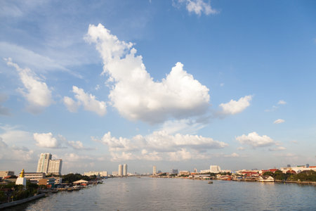 Chao Phraya River. With buildings and skyscrapers near river. During the day, the sky is clear.の写真素材