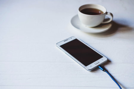 Charge the mobile phone on the table.