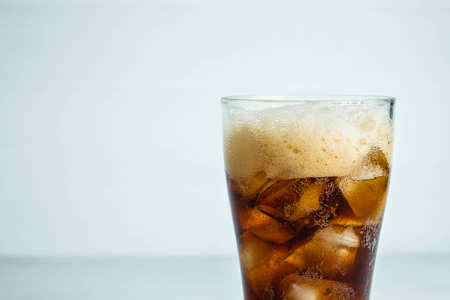 Cola, soft drinks in a glass on a white background