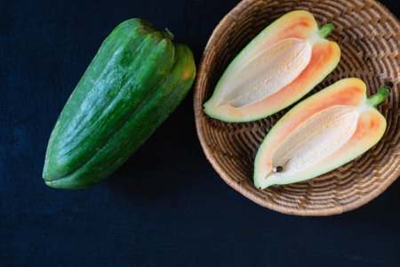 ripe papaya fruit on wooden back ground