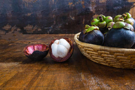 .Fresh mangosteen fruit in a basket on the table
