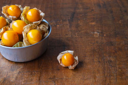 Cape Gooseberry fruit In a bowl on a wooden background