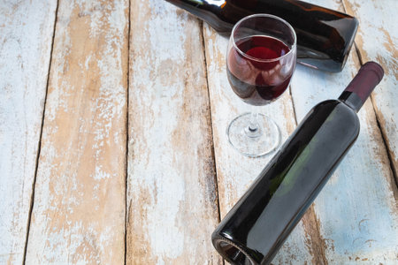 .Wine Glass and Wine Bottle on Old Wood Backgroundの写真素材