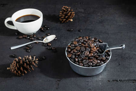 .Cup of coffee and coffee beans On a black background