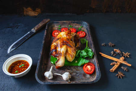 Grilled chicken dishes and dipping sauce From the oven on a black backgroundの写真素材