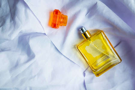 .Perfume and perfume bottles on a white cloth floorの写真素材
