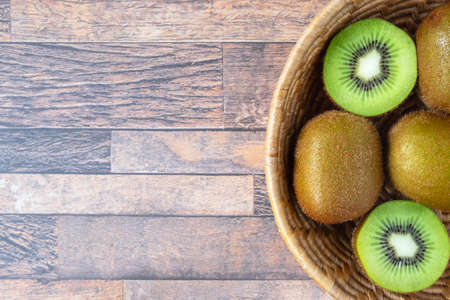 .Fresh kiwi fruit in bowl on tableの写真素材