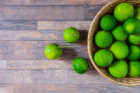 Fresh lime in green basketの写真素材