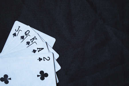 Gambling cards on a black cloth background