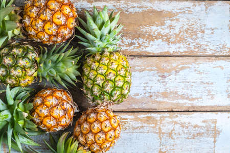 .Pineapple fruit on a wooden background