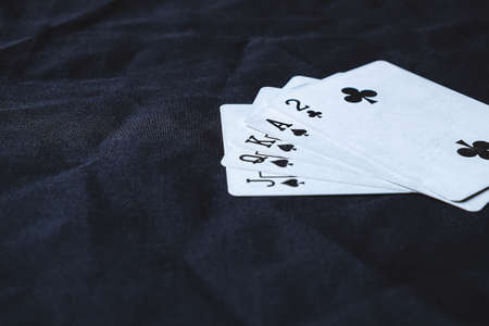 Gambling cards on a black cloth background