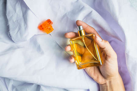 Woman applies perfume on her wrist