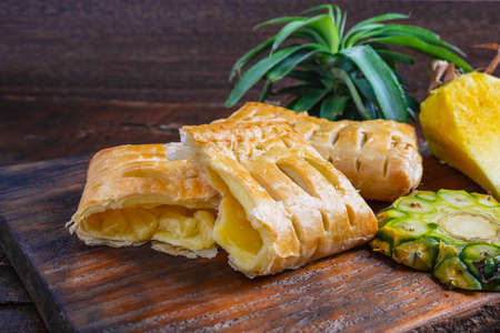 Pineapple Pie and Pineapple Fruit on a Wooden Backgroundの写真素材