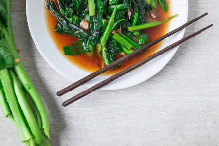 Fried Kale with Oyster Sauce menu on wooden tableの写真素材
