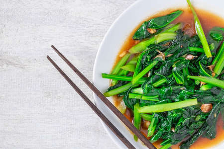Fried Kale with Oyster Sauce menu on wooden tableの写真素材