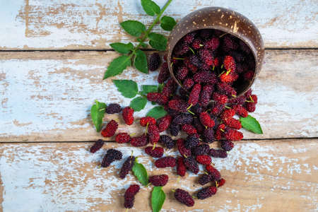 .Healthy fresh mulberry on a wooden table
