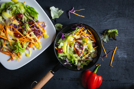 .Bowl of vegetable salad on black background.