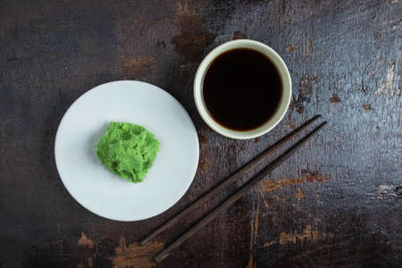 Soy sauce and wasabi on a wooden backgroundの写真素材