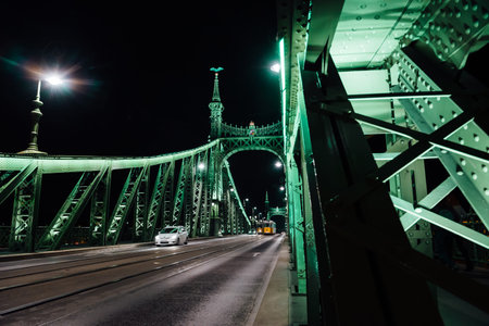 Old Iron Bridge at night in the light of streetlights across the Danube River in Budapest Hungary