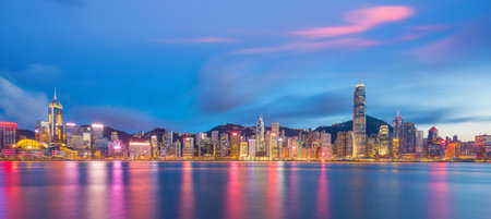 Panoramic view of Victoria Harbor and Hong Kong skyline in China at sunsetの写真素材