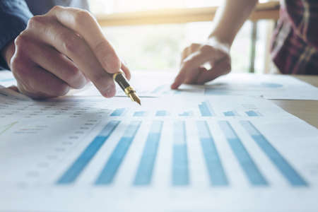 Two Business man or accountant working Financial investment, writing report Analyze business and...