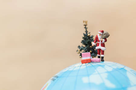 Miniature people : Santa Claus holding gift for kidsの写真素材