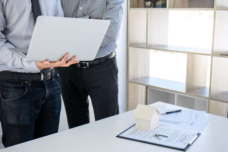 Car and Home insurance concept, broker agent presenting and consult to customer to decision making sign insurance form agreement, home and car modelの写真素材