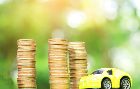 Car and coin natural blurred background Concept of car insuranceの写真素材