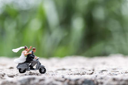 Miniature people : Couple riding the motorcycle