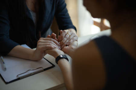Asian woman patient talking with her therapist in the office. Healthcare concept of professional psychologist doctor consultの写真素材