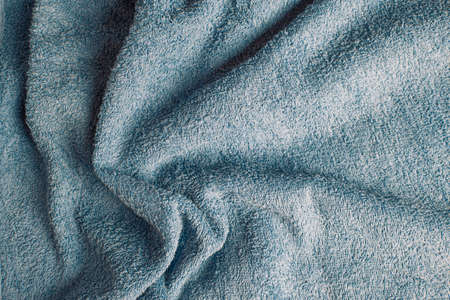 Top view of a light blue towel with some wrinkles