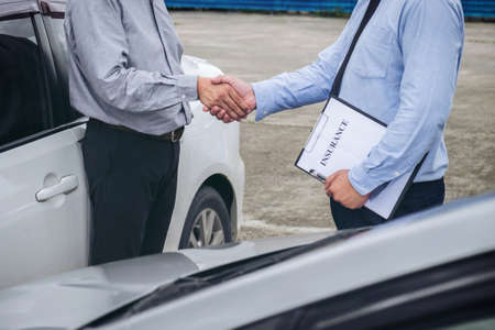 Insurance Agent and customer shaking hands, Traffic Accident and insurance conceptの写真素材